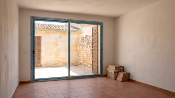Empty apartment in a Mallorcan development with plain durable finishes and film on the frames