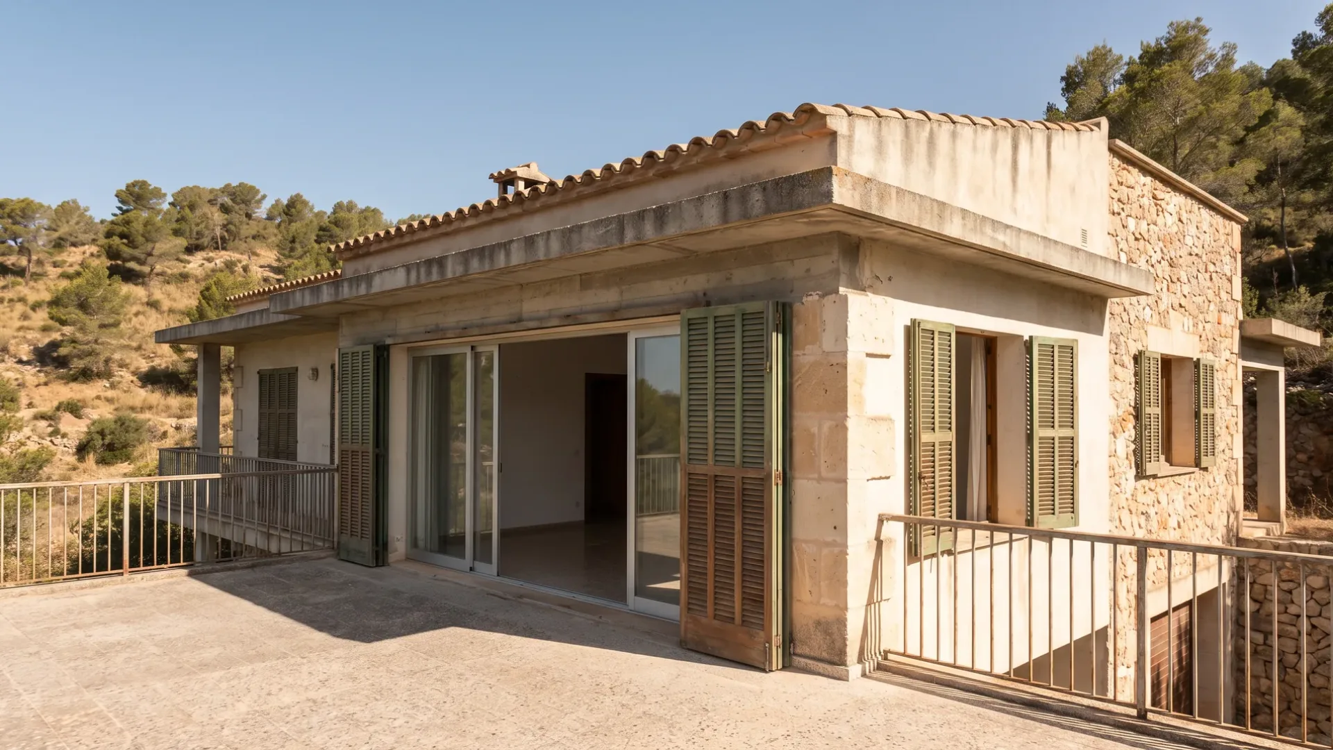Concrete-framed Mallorcan villa from the nineteen eighties with a flat roof and sliding doors