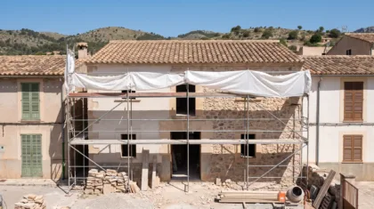 Mallorcan house under renovation with the work sheeted over and the site closed for the day